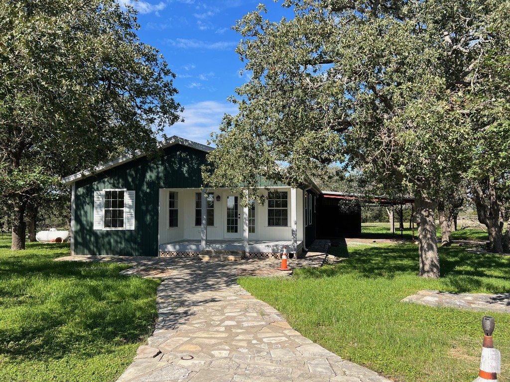 a front view of house with yard and green space