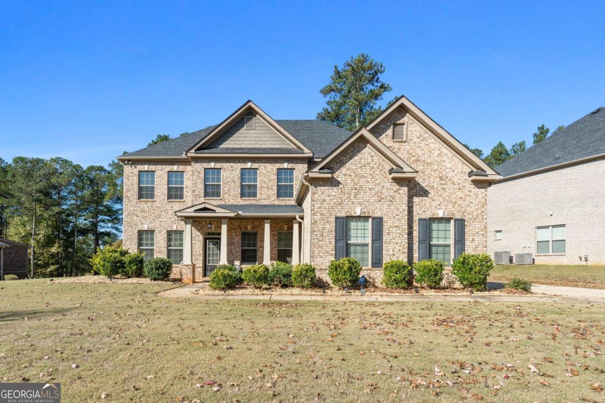 a front view of a house with a yard