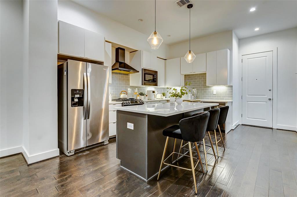 Kitchen with stainless steel appliances and quartz countertops.