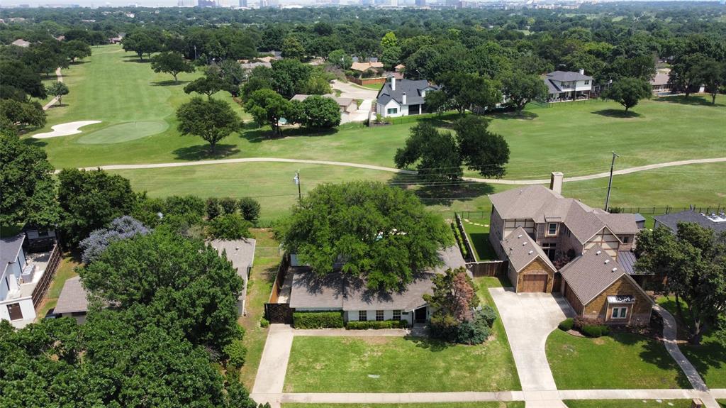 an aerial view of residential houses with outdoor space and lake view