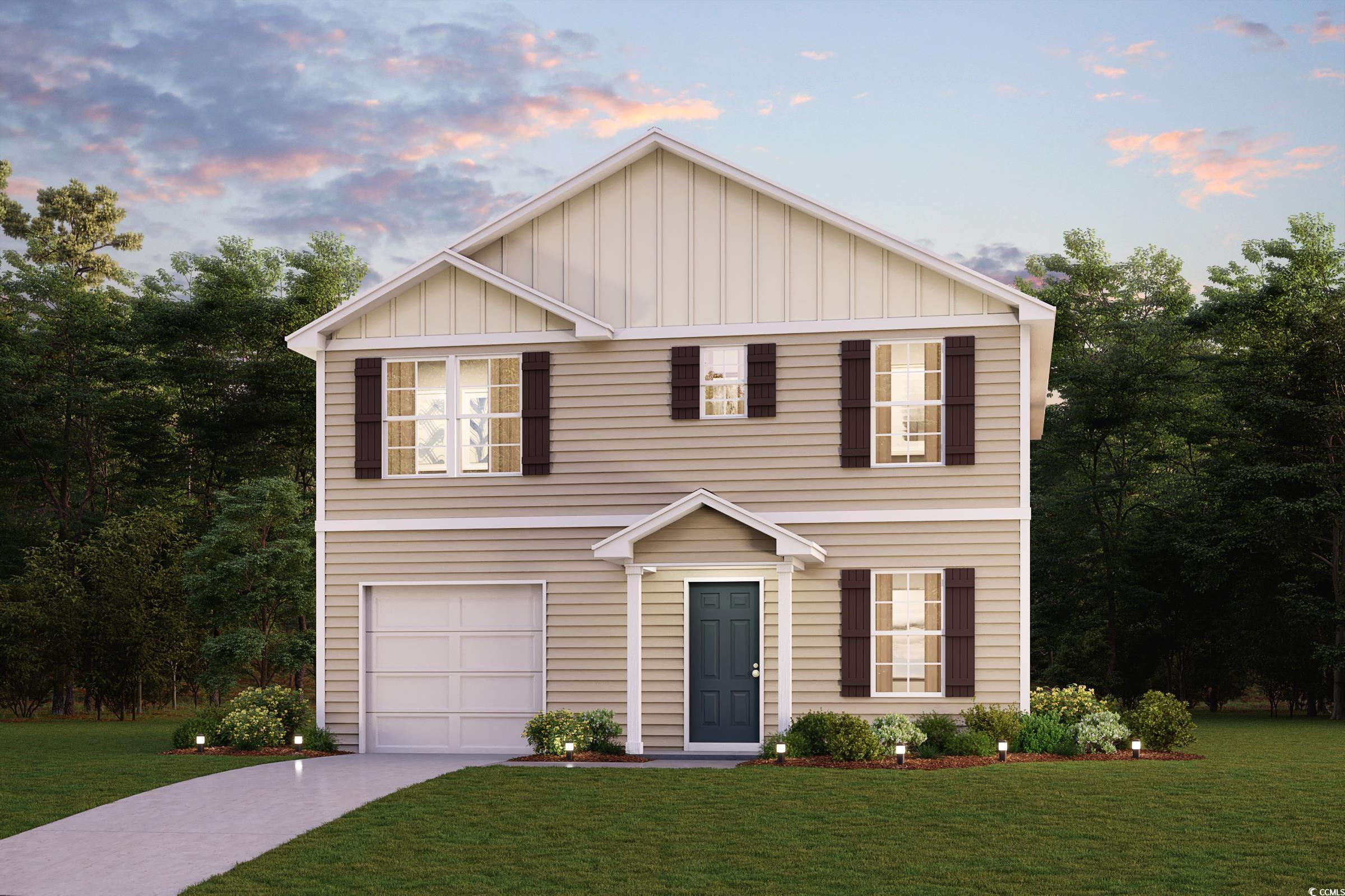 View of front of property with a garage and a lawn