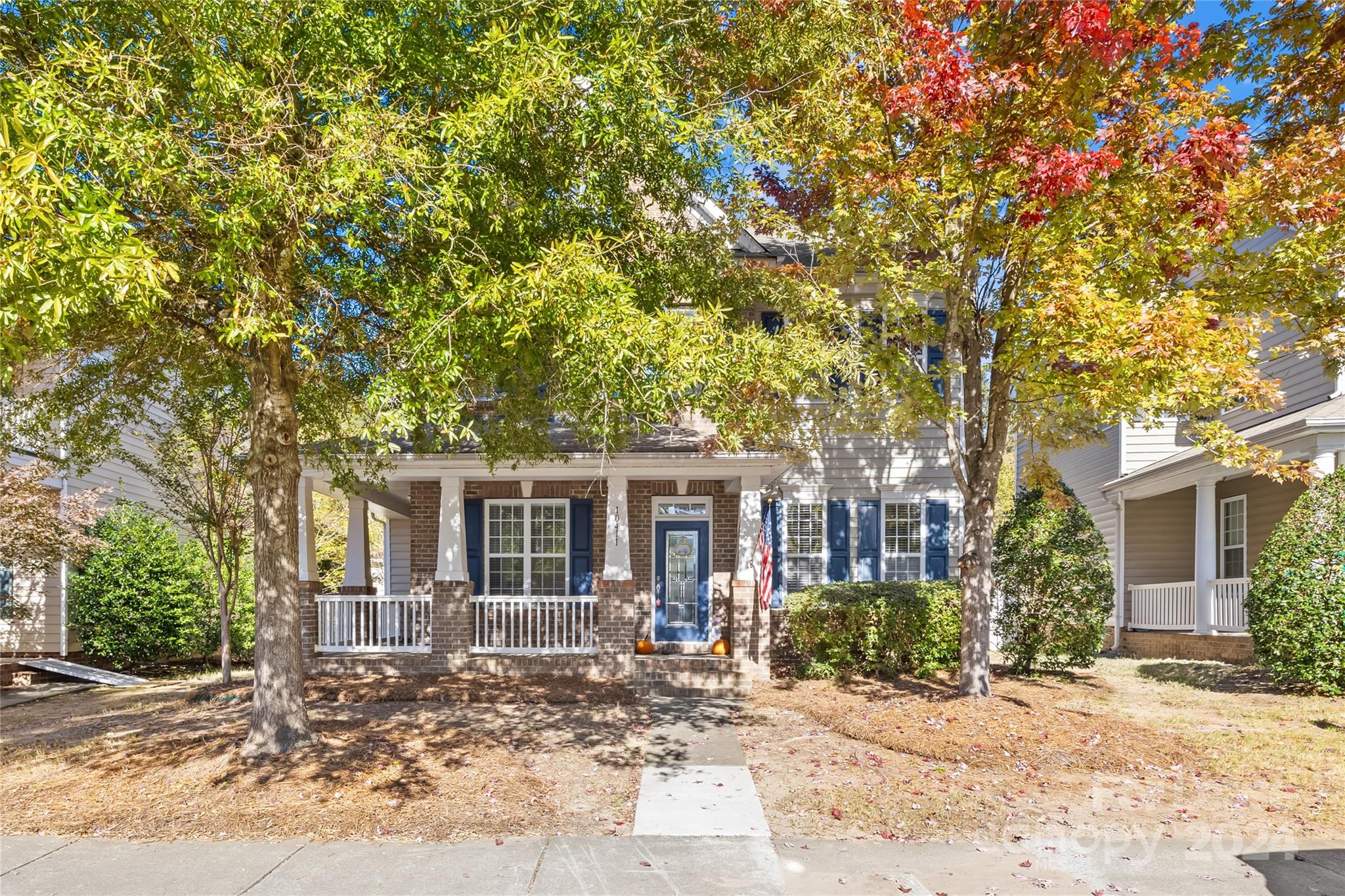 front view of a house with a tree