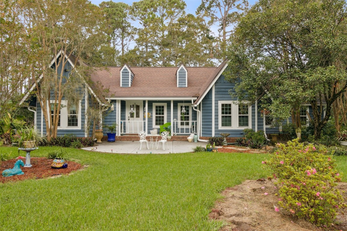 a front view of a house with a yard and sitting area