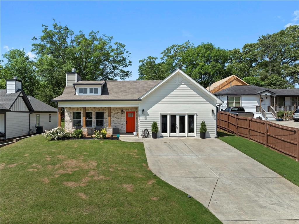 a front view of a house with a garden and trees