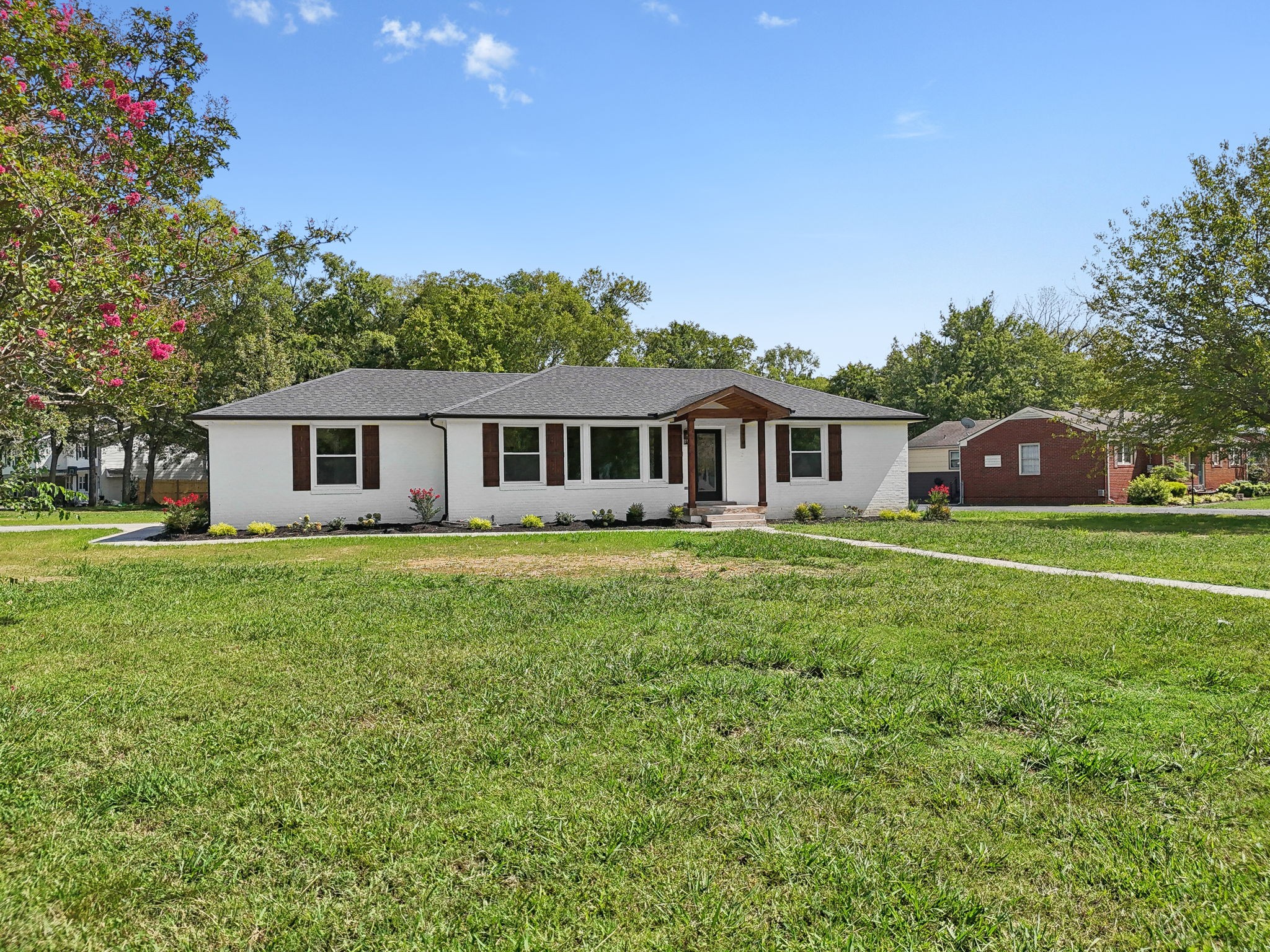 a front view of house with yard and green space