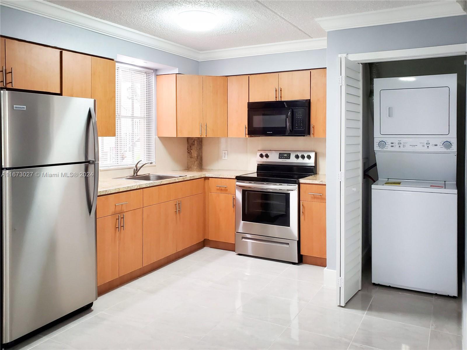 a kitchen with stainless steel appliances a refrigerator stove and microwave