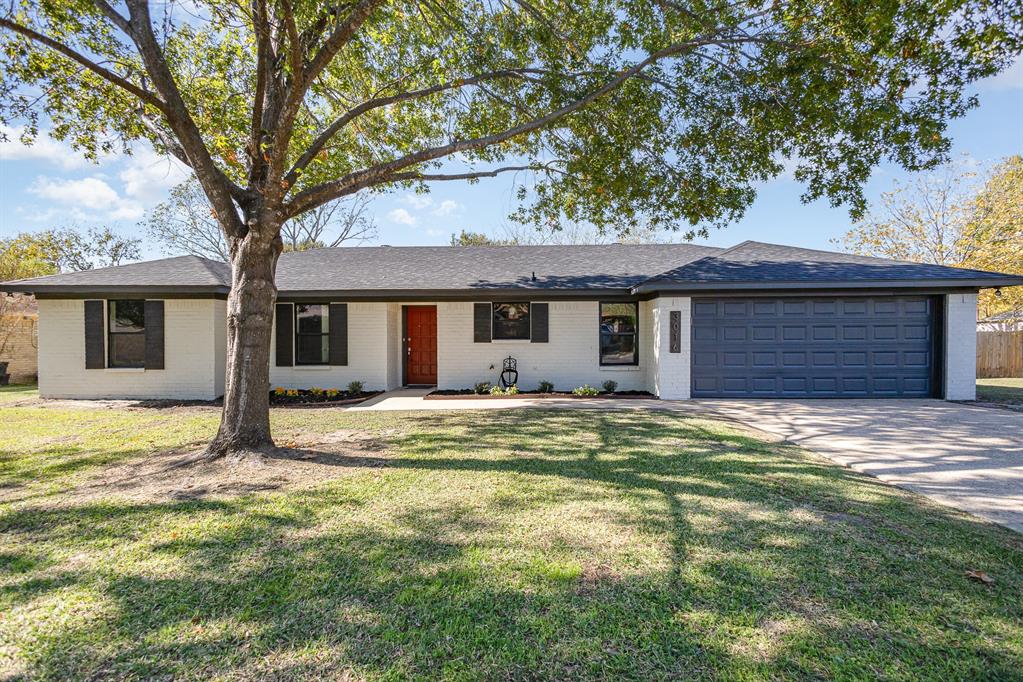 a house that has a tree in front of it