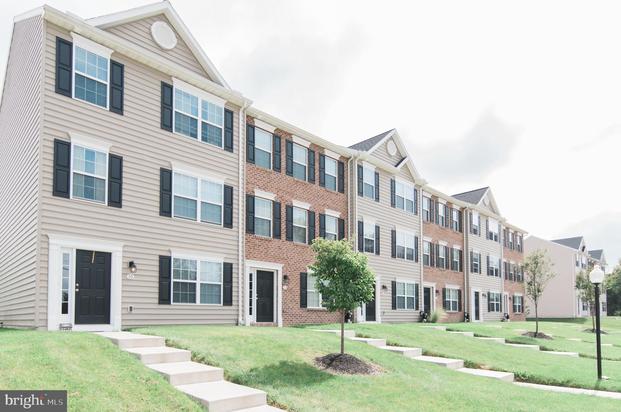 a front view of a building with a yard