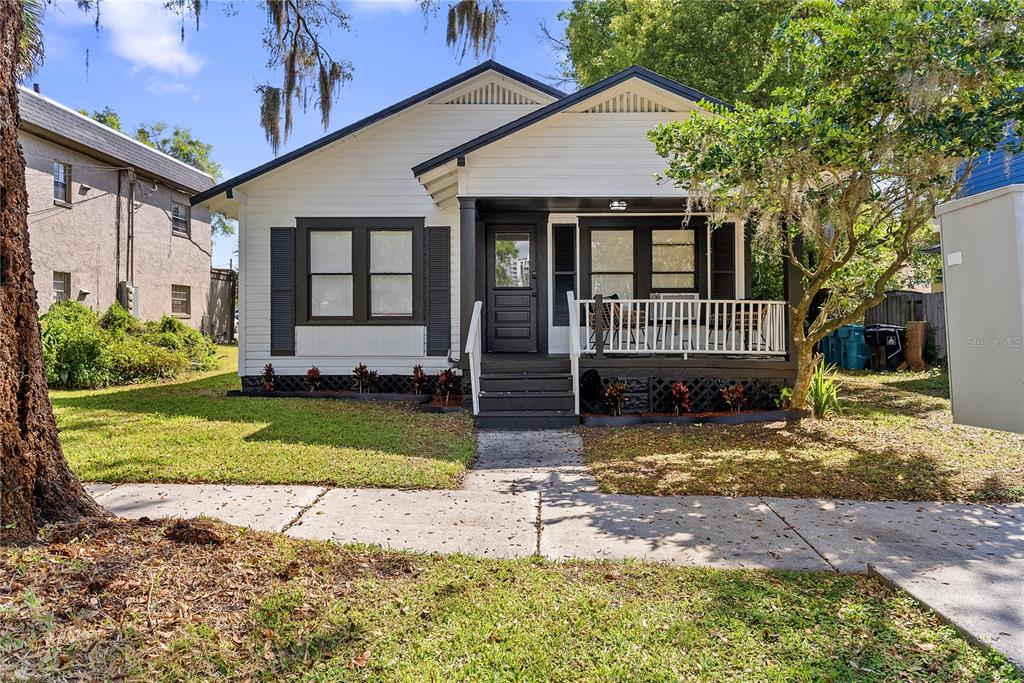 a view of a house with a yard and plants