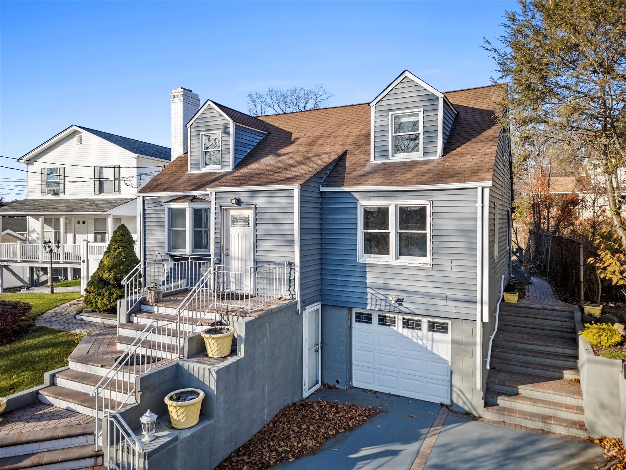 Cape cod house featuring a garage