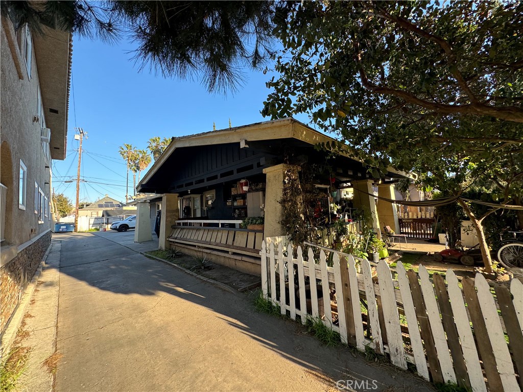 a view of a house with wooden fence