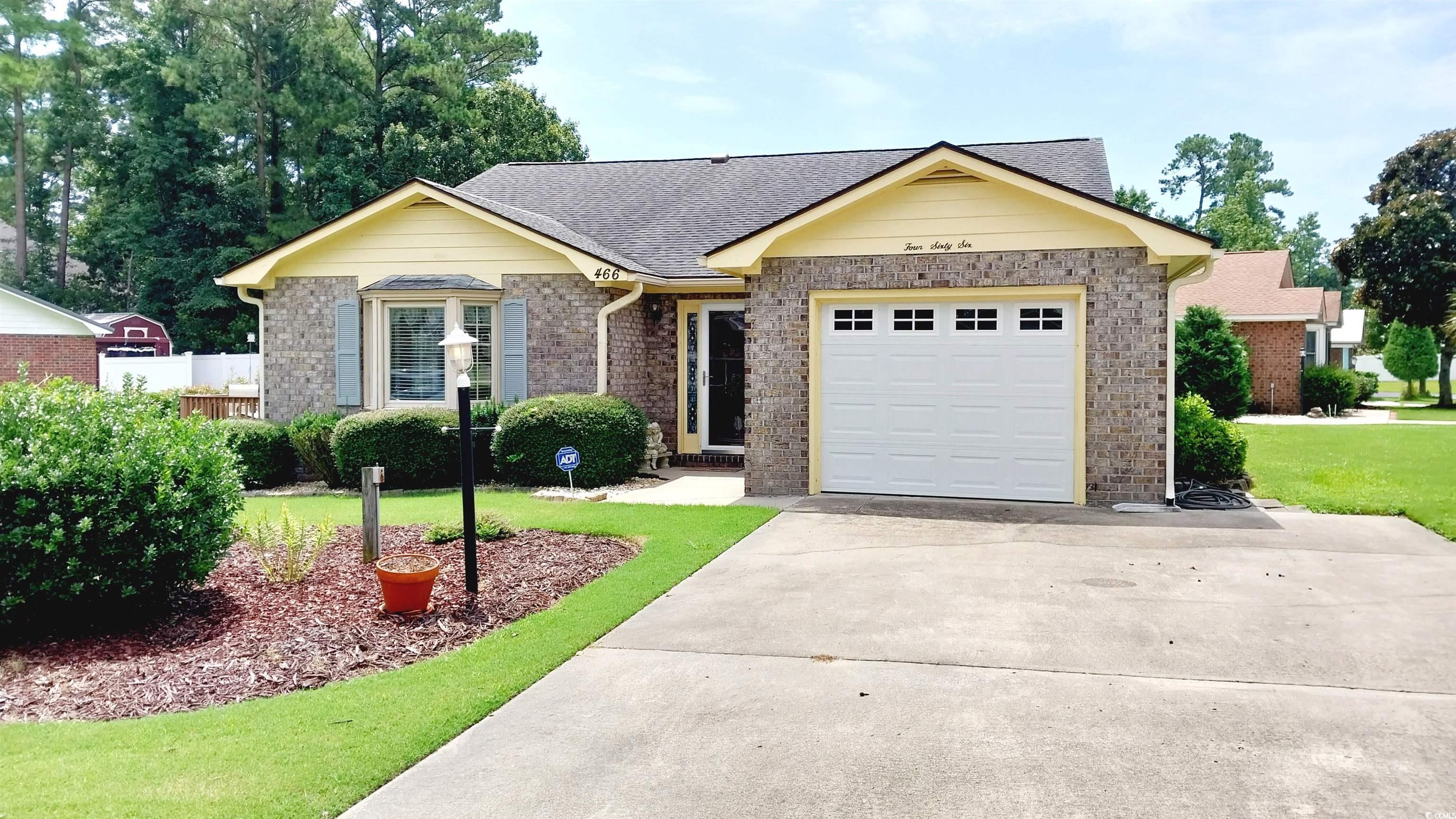 Single story home featuring a garage and a front l