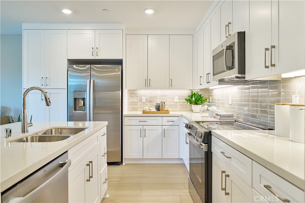 a kitchen with a sink stove and refrigerator