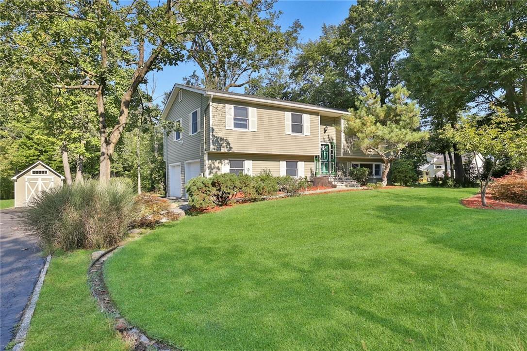 a view of house with backyard