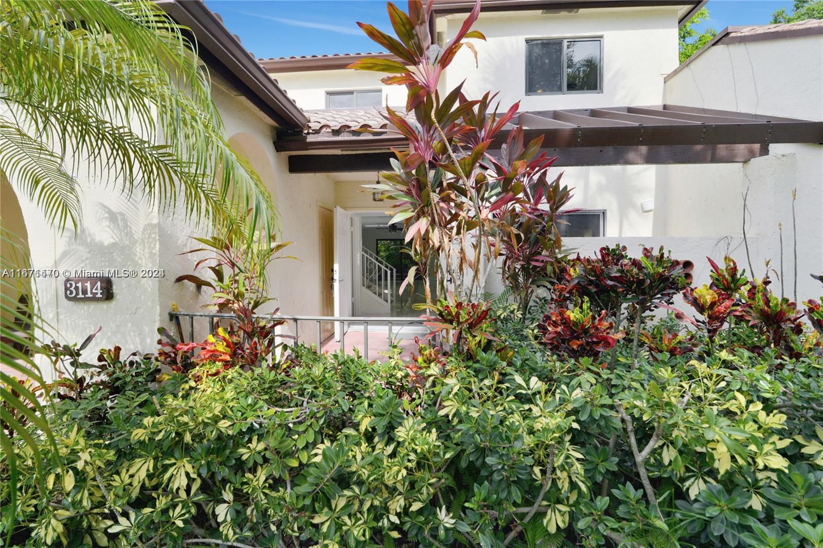 a view of a house with a flower garden