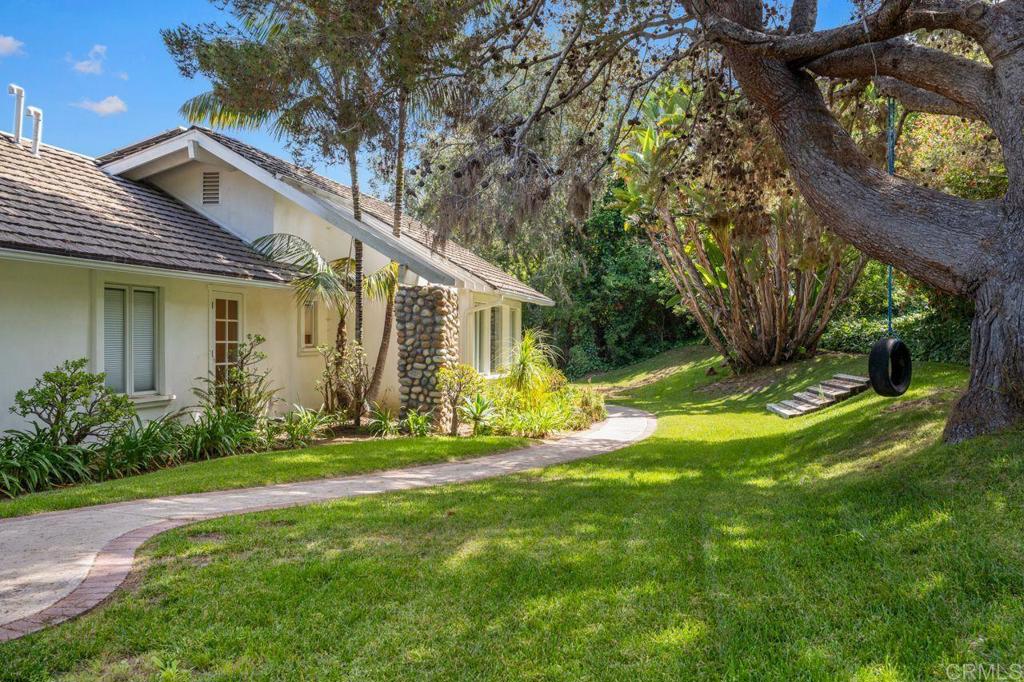 a view of a house with backyard and sitting area