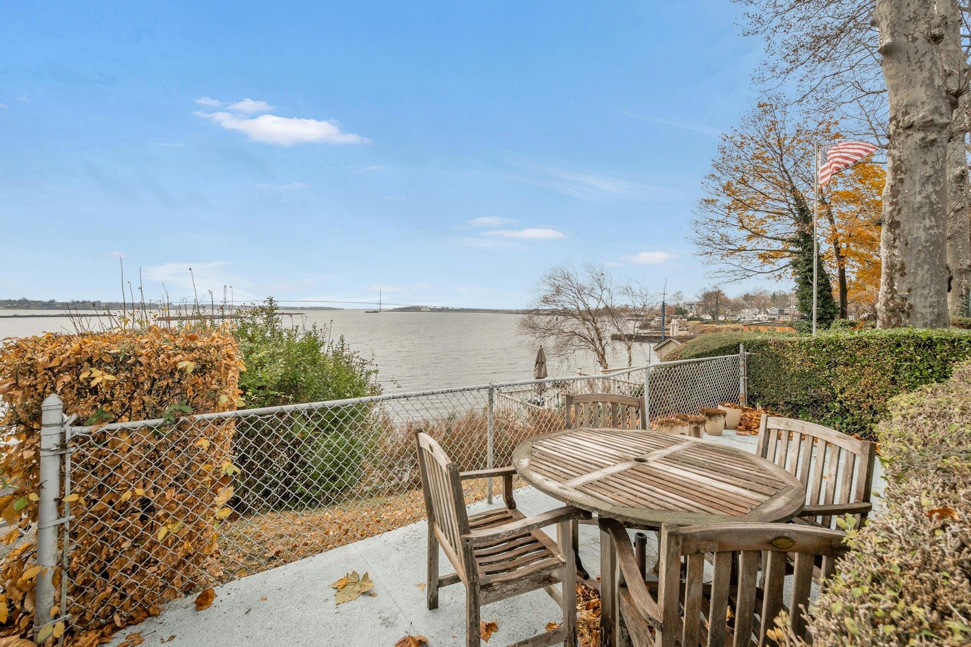 a view of a roof deck with chair and wooden floor