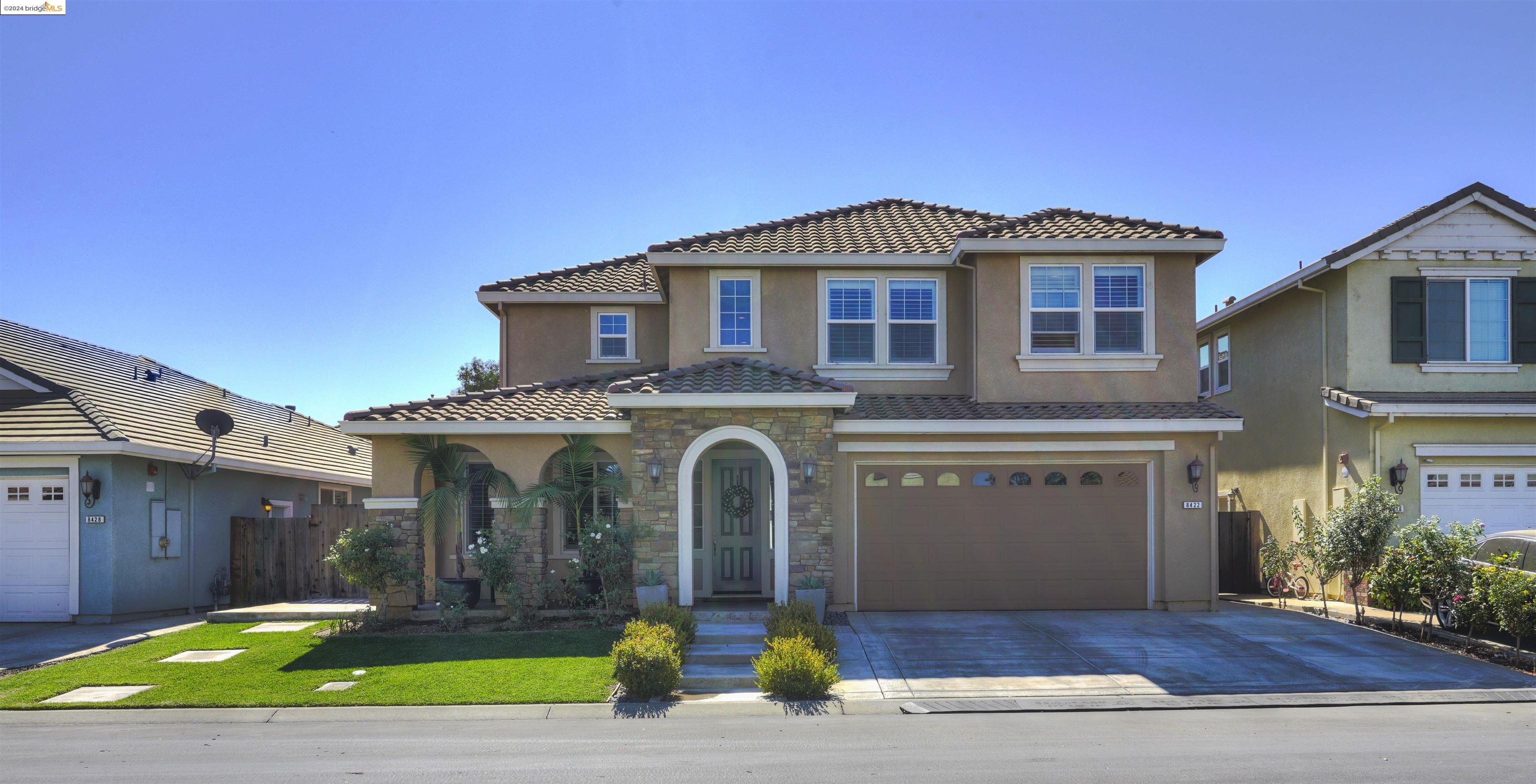 a front view of a house with garden