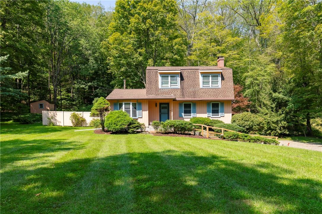 a view of a house with a yard patio and a table and chairs