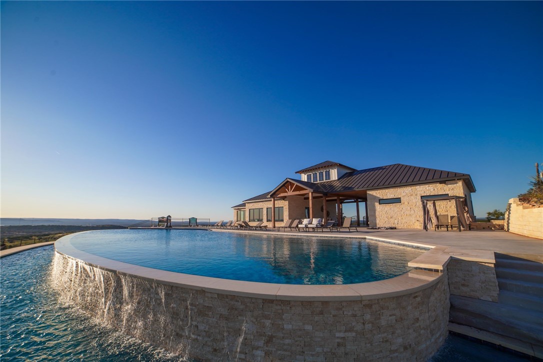 a view of swimming pool with outdoor seating