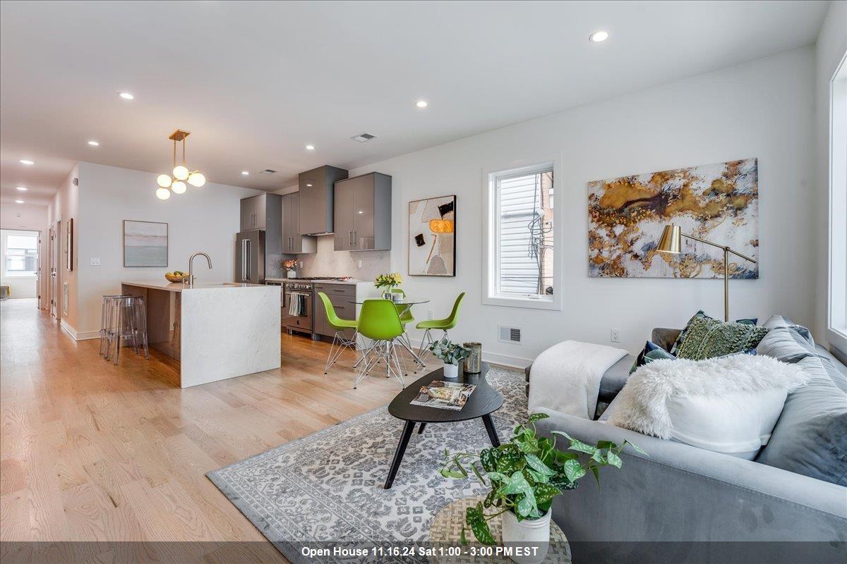 a living room with furniture and kitchen view