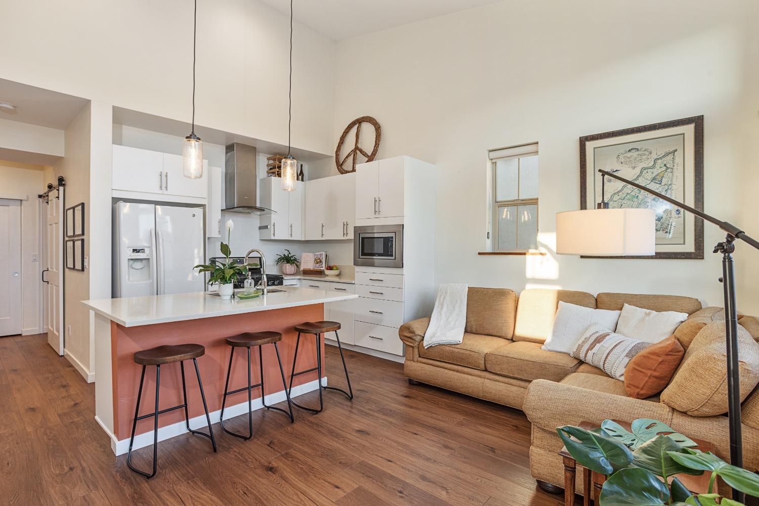 a living room with furniture and wooden floor