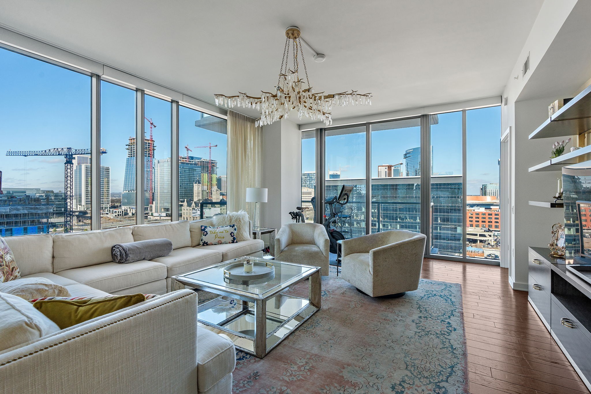 a living room with furniture and a chandelier