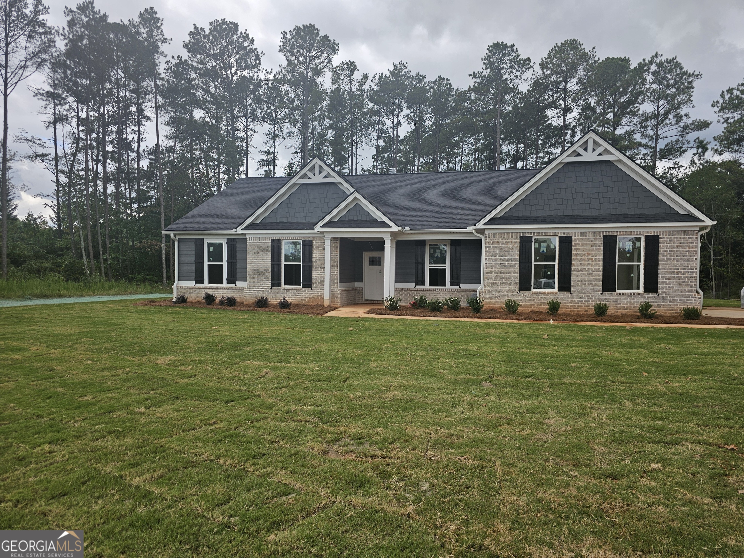 a front view of a house with a garden