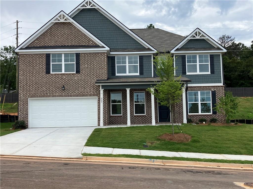 a front view of a house with a yard