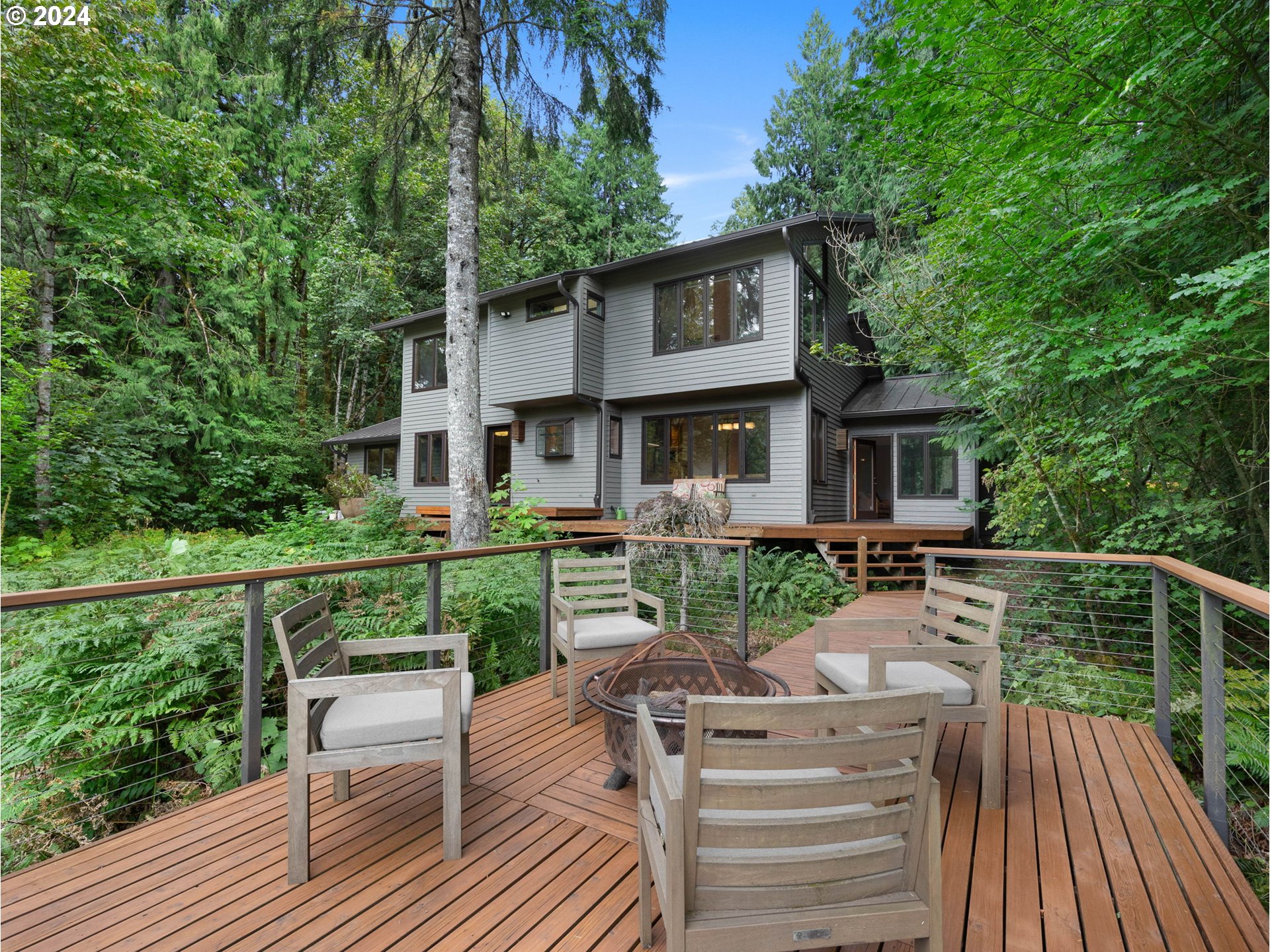 a view of a roof deck with table and chairs wooden floor and fence