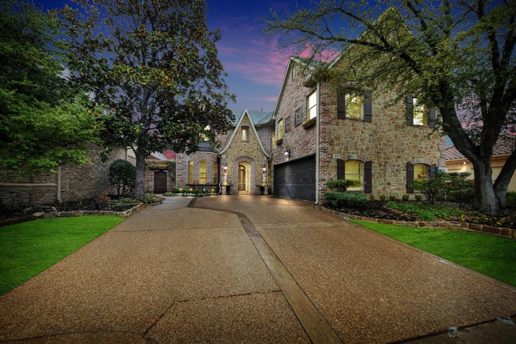 a front view of a house with yard and green space