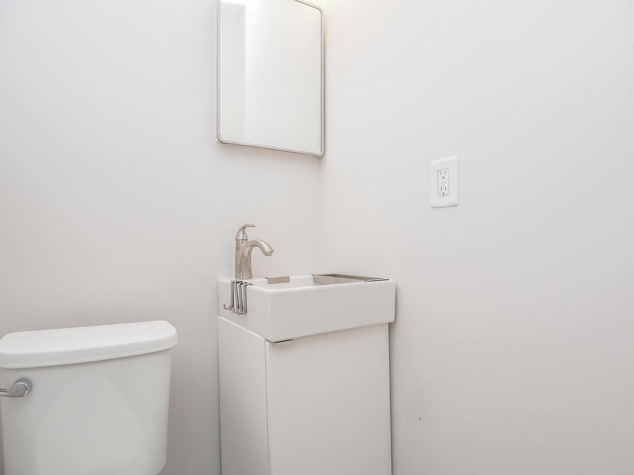 a view of bathroom with a sink and a toilet