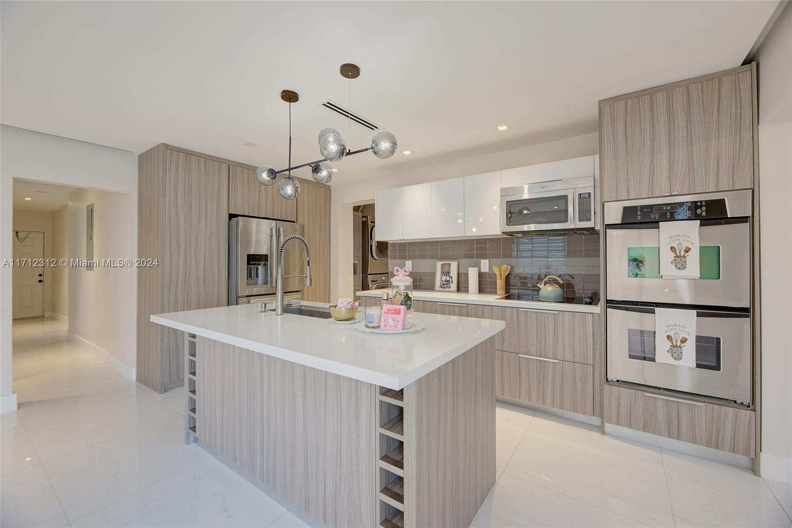 a kitchen with kitchen island a sink appliances and cabinets