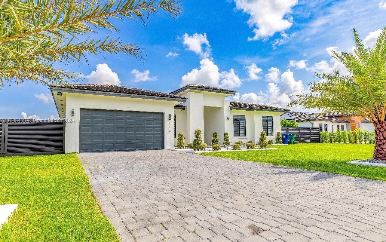 a front view of a house with a yard and garage