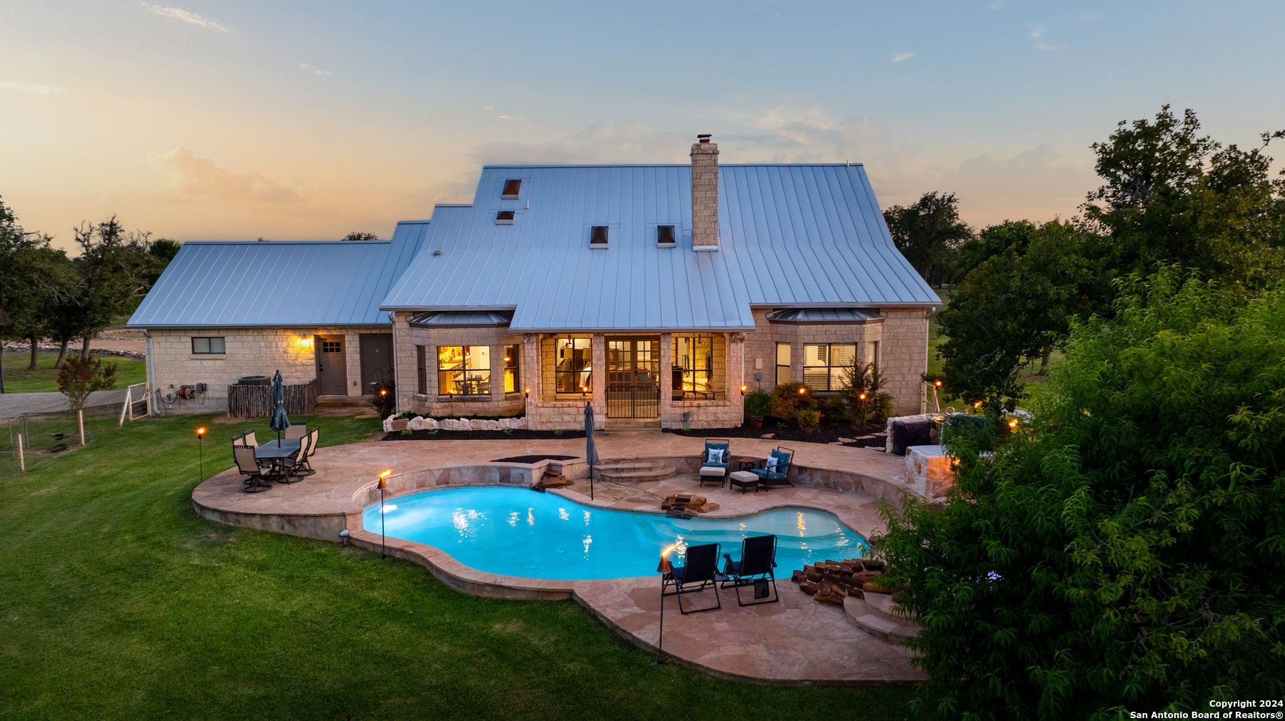 a view of a house with backyard and sitting area