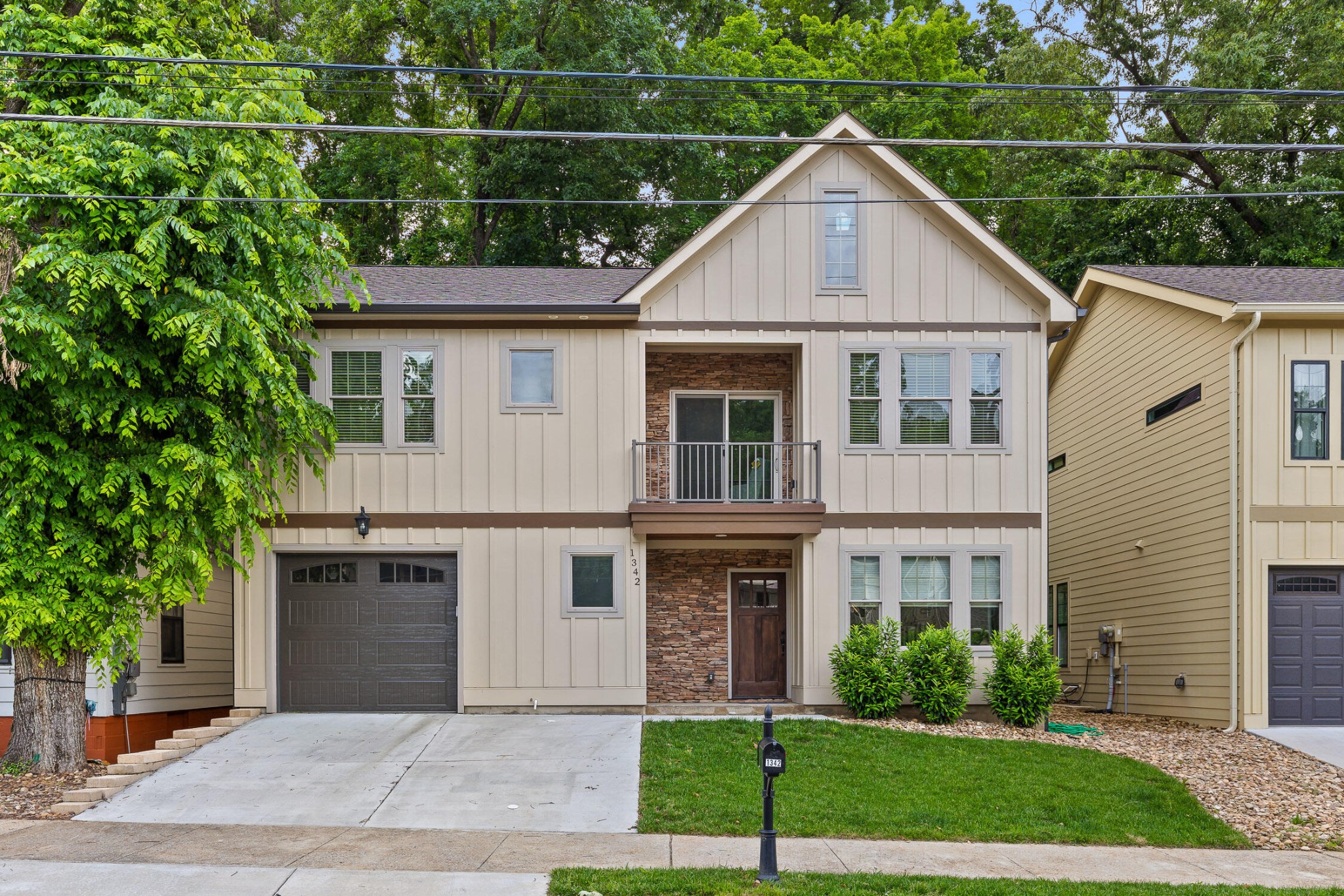 a view of a yard in front view of a house with garage