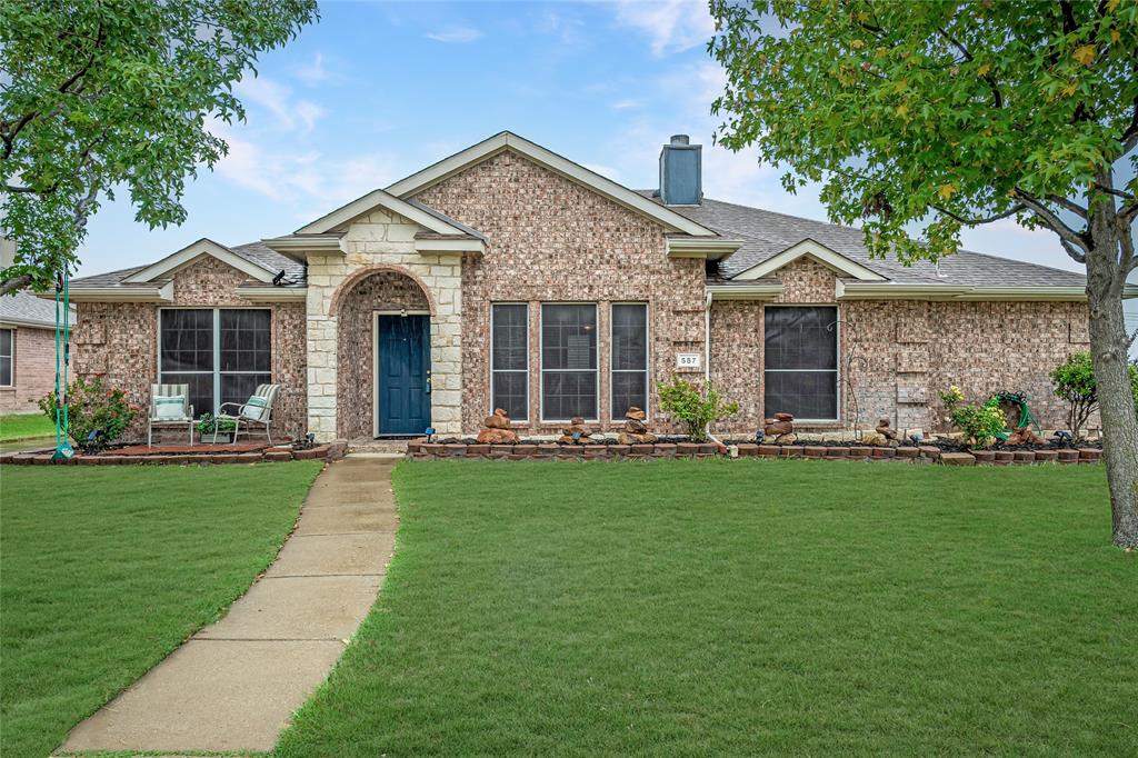 a front view of house with yard and green space