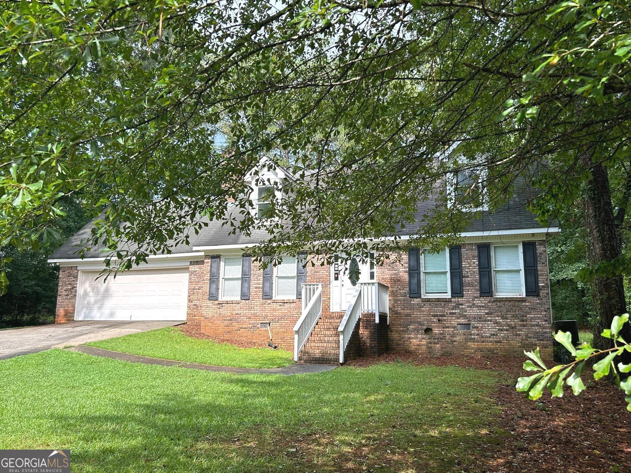 a view of a house with backyard porch and sitting area