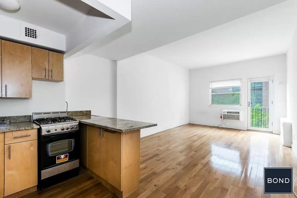 a kitchen with a stove and a wooden cabinets