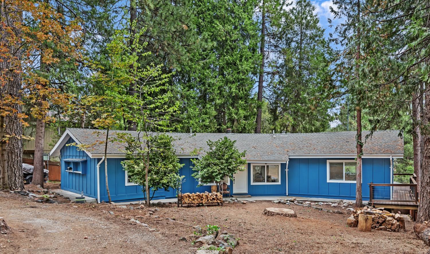 a view of a house with a tree next to a yard