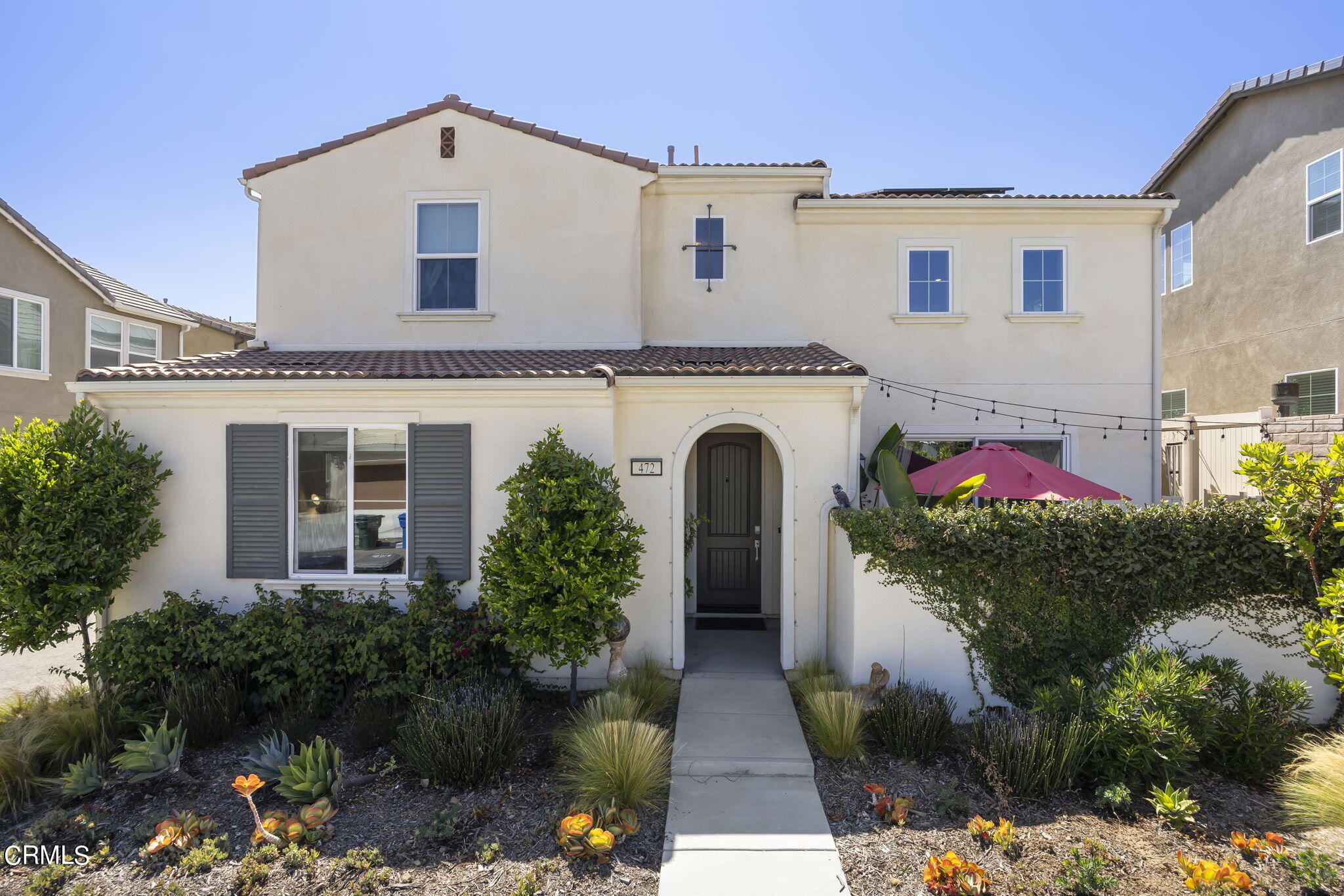 a front view of a house with garden