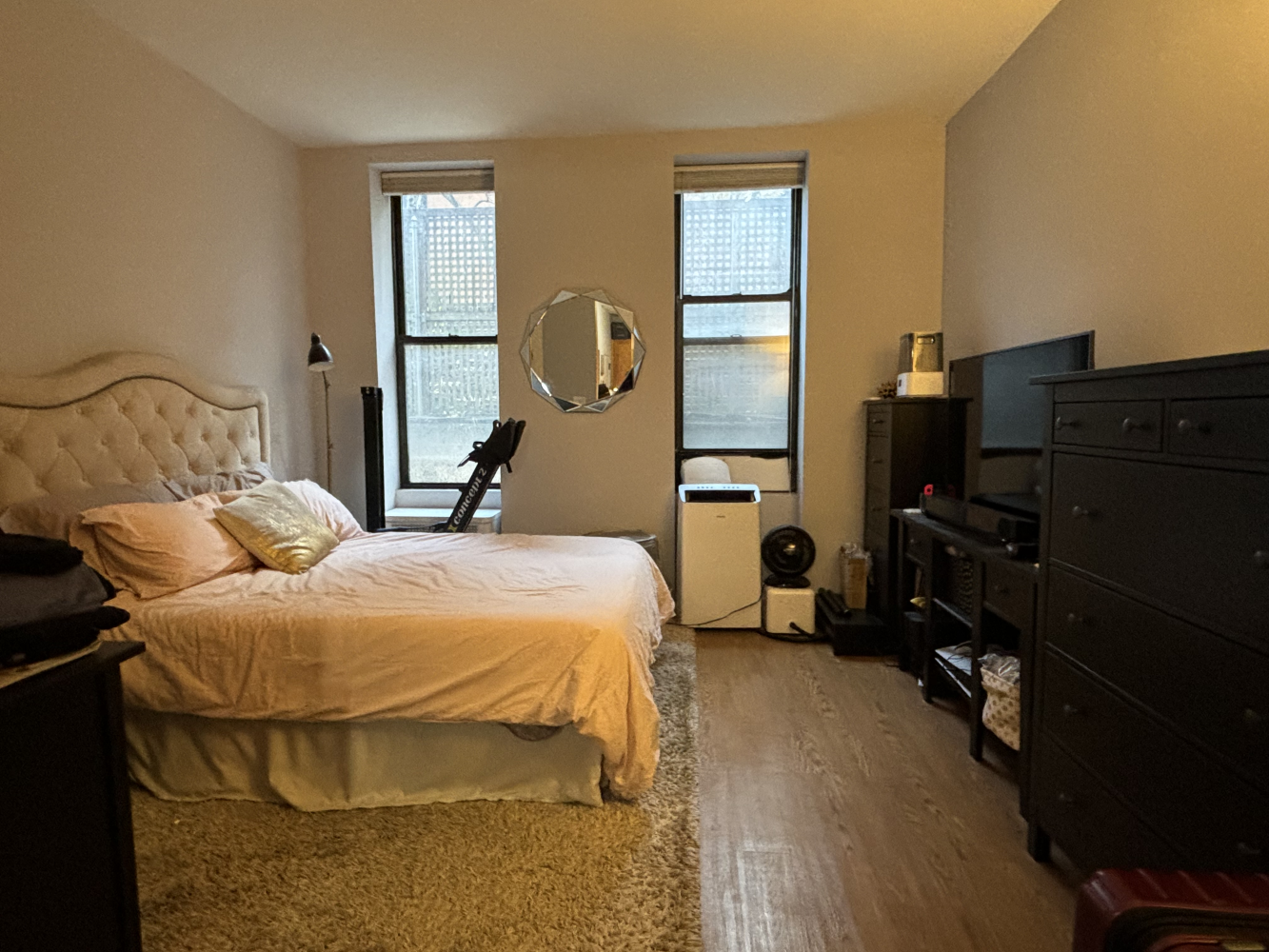 a bedroom with a bed and wooden floor