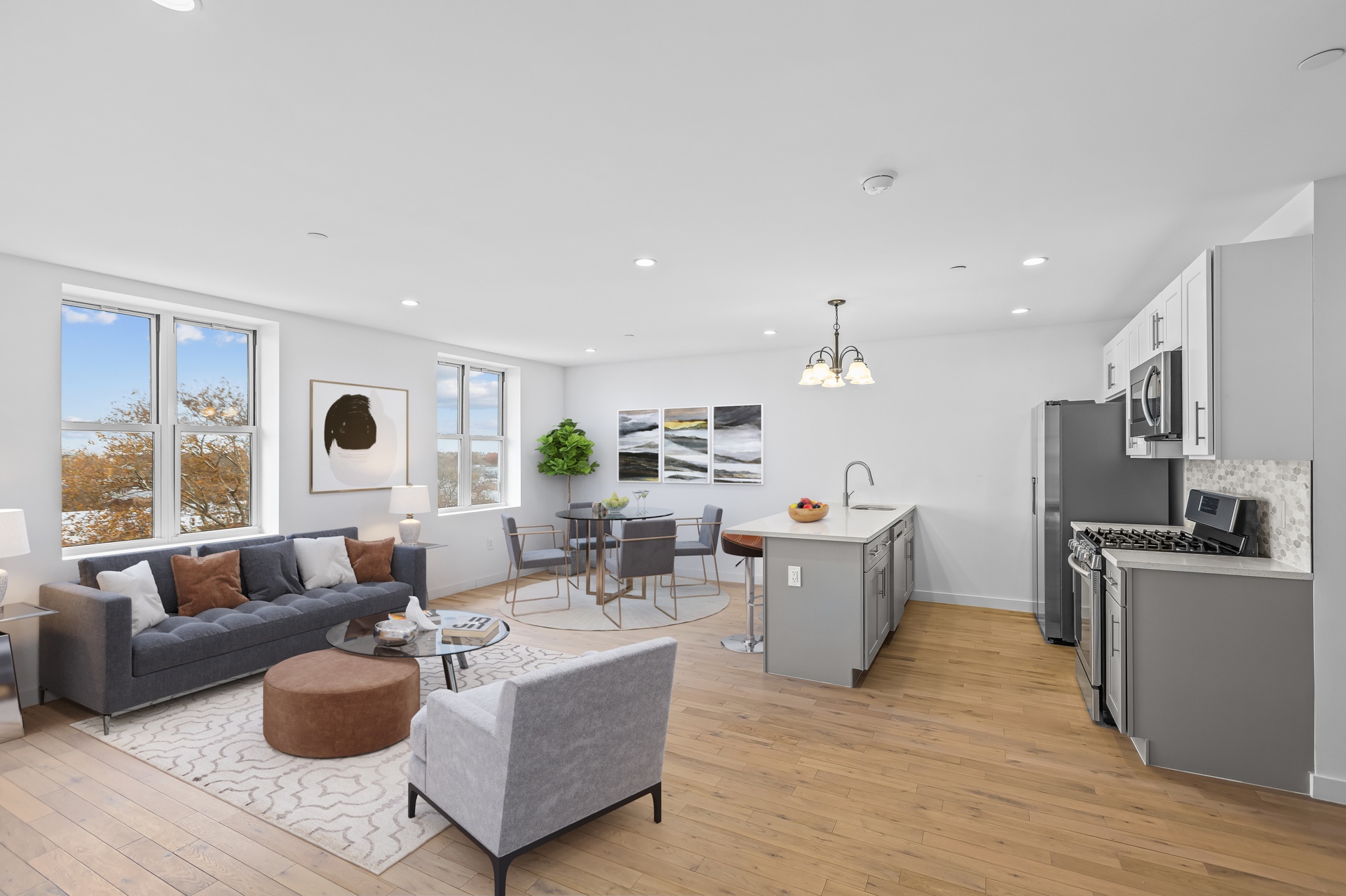 a living room with furniture and a wooden floor