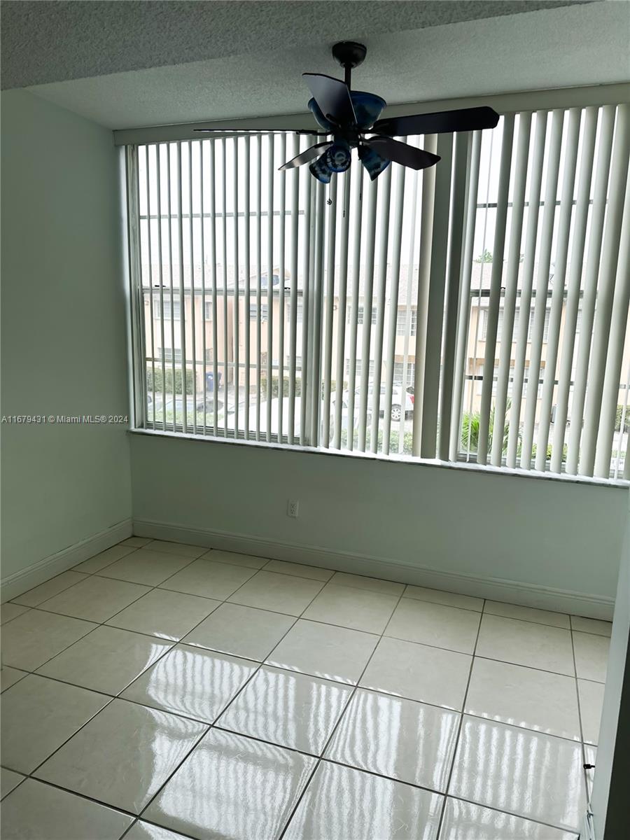 a view of an empty room and a window