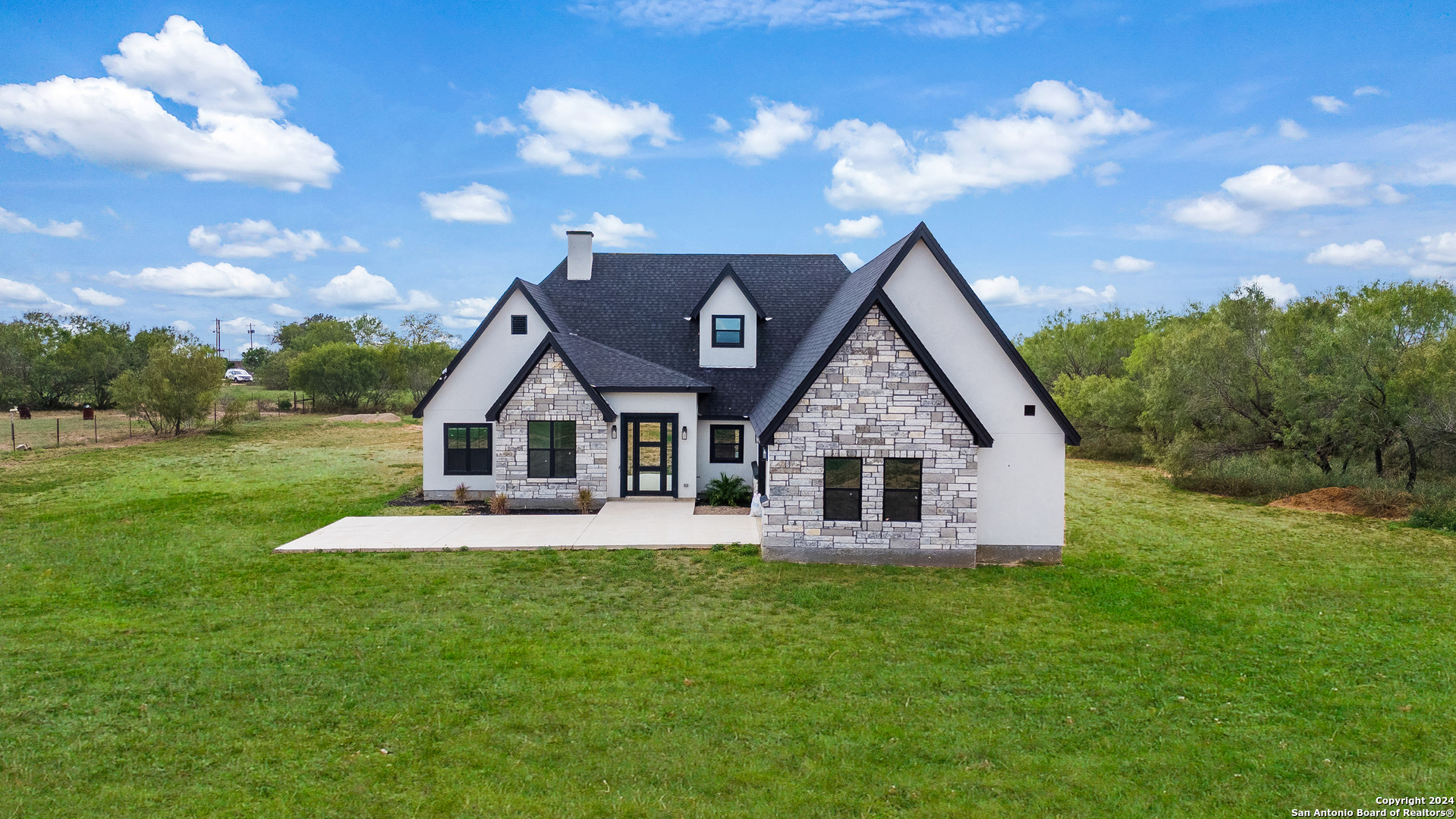 a front view of house with yard and green space