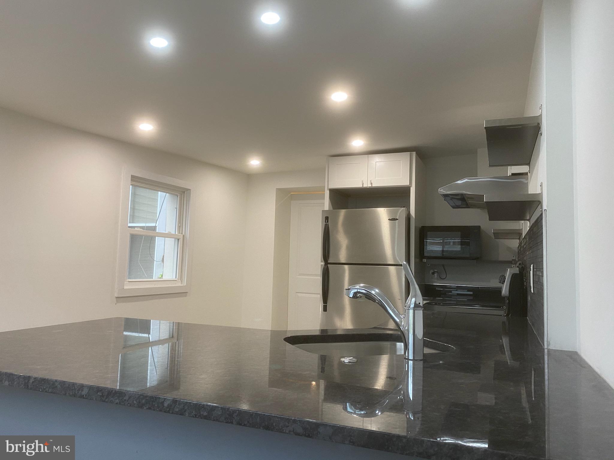 a kitchen with refrigerator and window