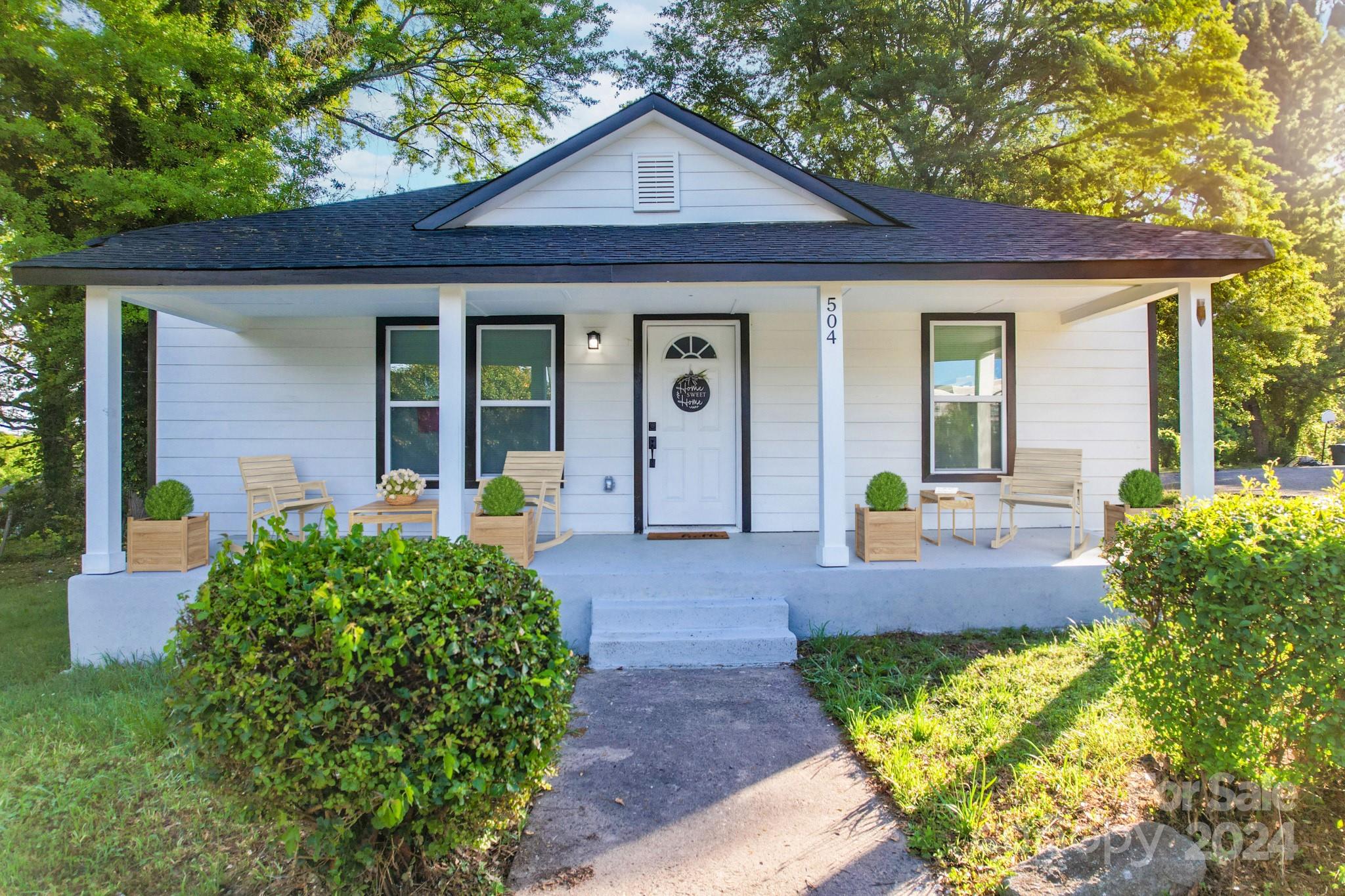 a front view of a house with garden