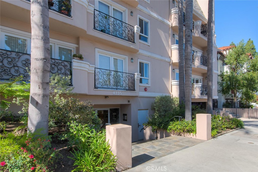 a front view of a multi story building with yard