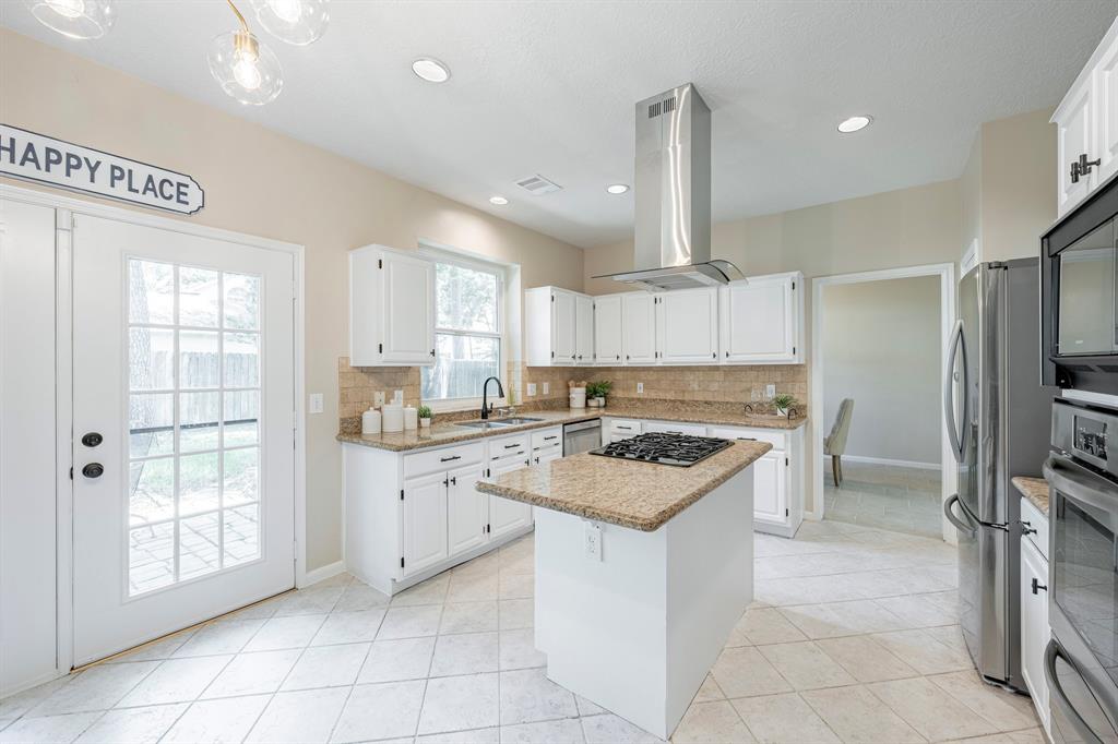 Natural light fills the expansive family room and is anchored by a gas log fireplace.