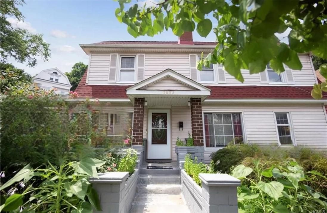 a front view of a house with a garden